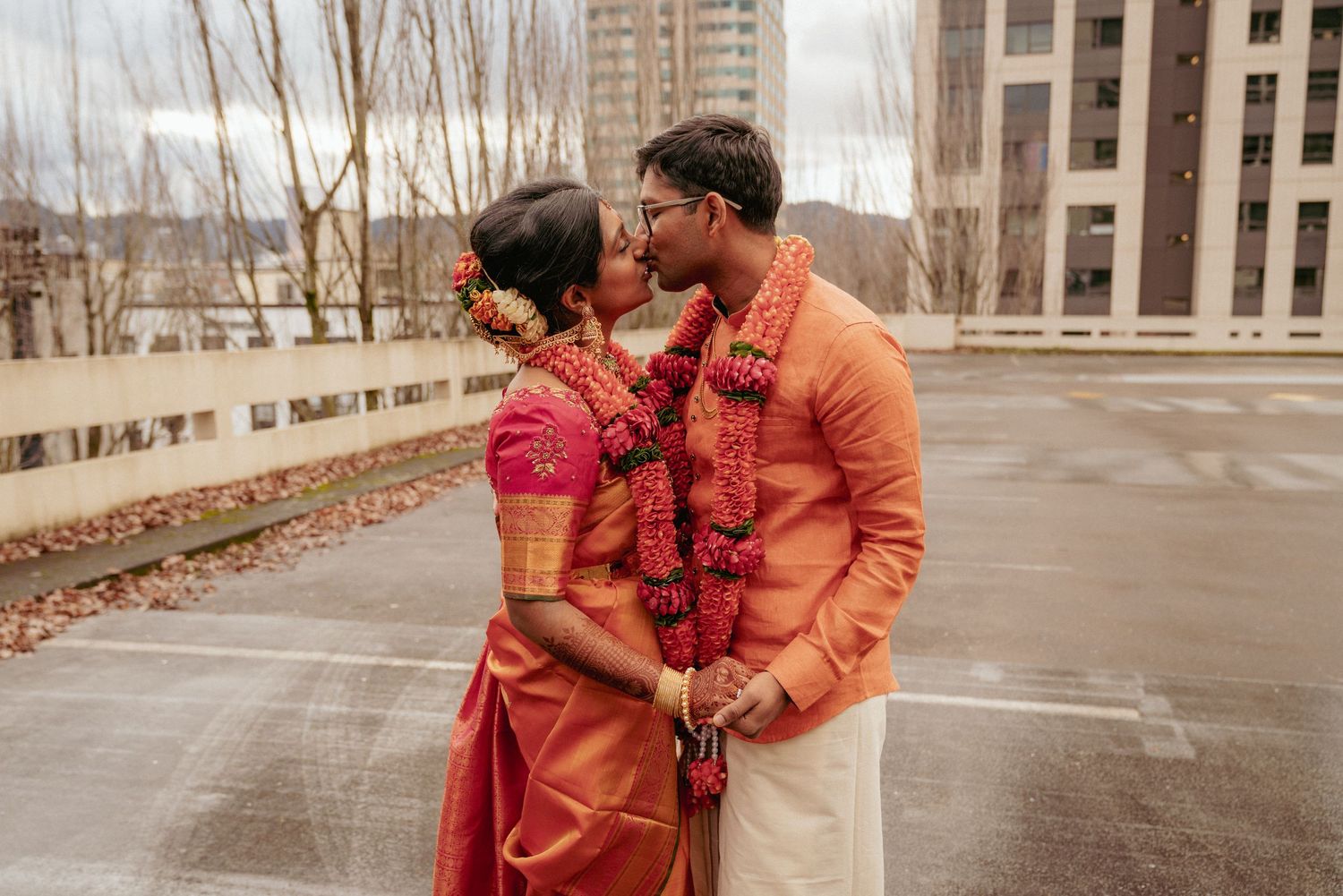 Bride and groom in traditional Indian attire share moment after wedding.