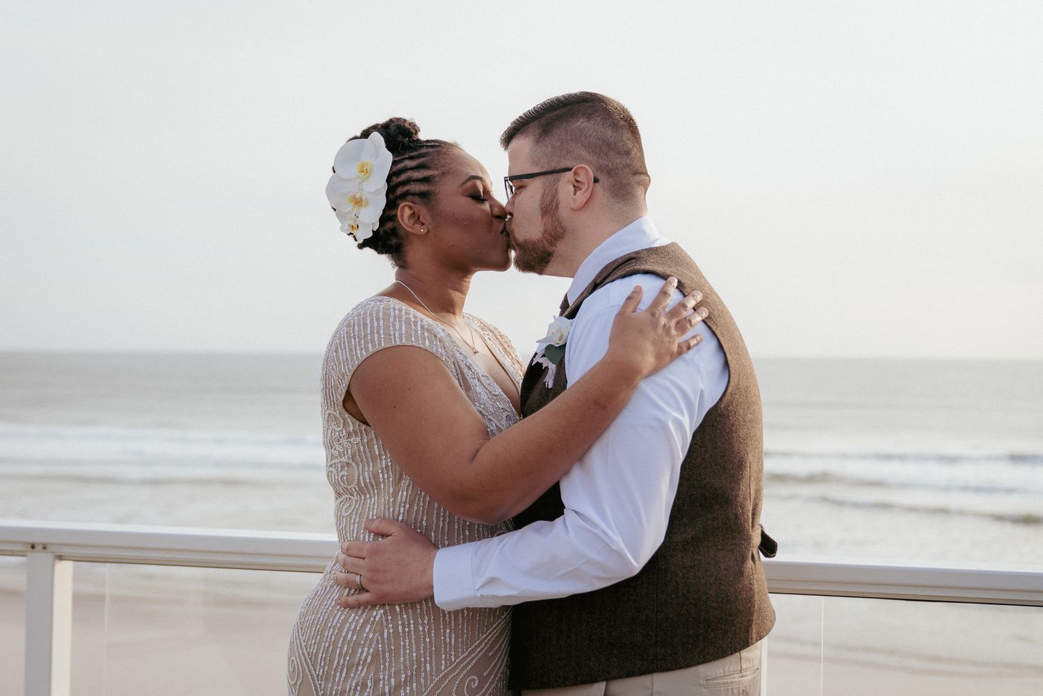 Black bride and white groom hug after ceremony, Oregon beach elopement.