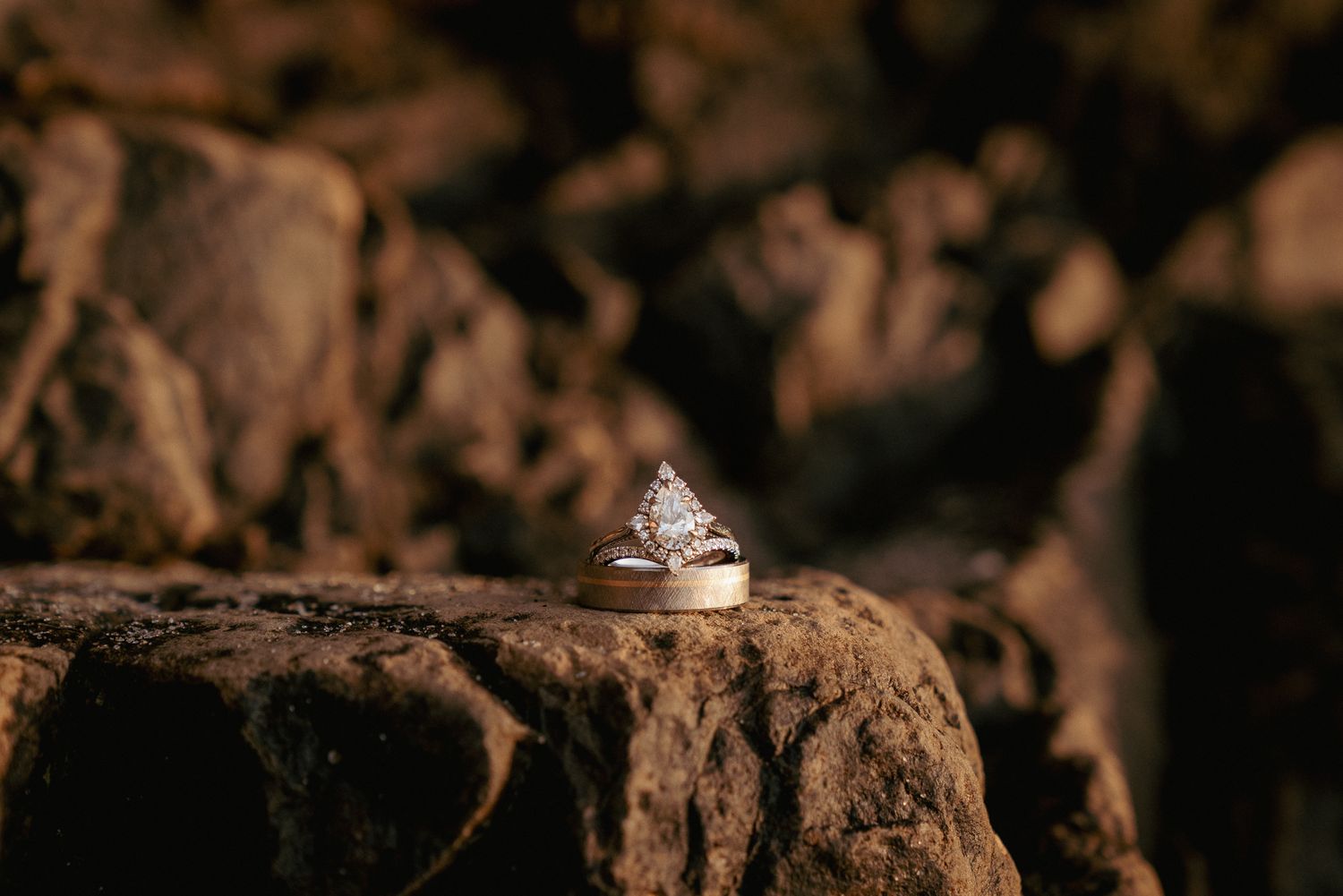 Engagement ring on rugged rock, earthy and moody Oregon elopement detail shot.