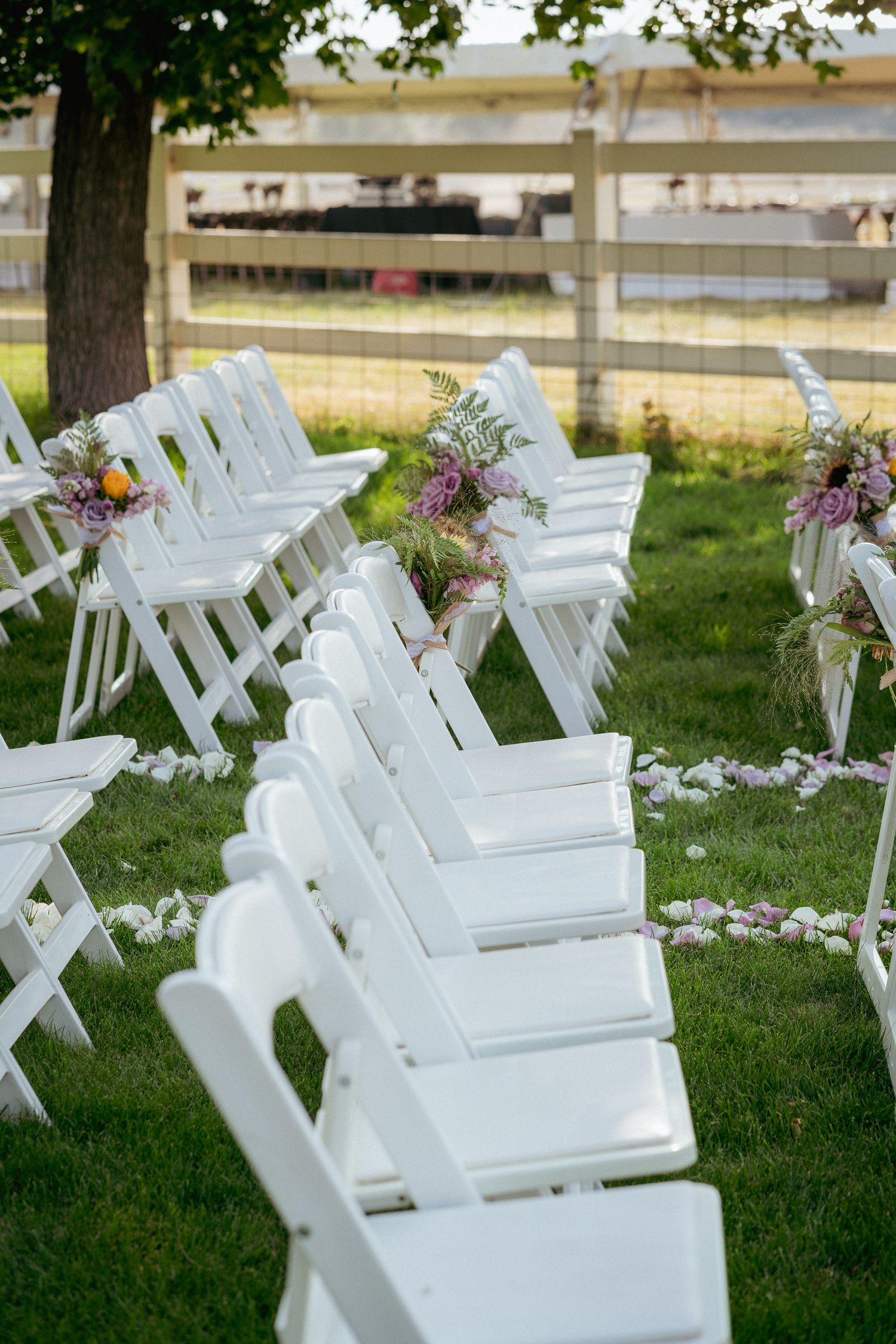 White chairs and floral aisle setup, garden wedding in PNW.