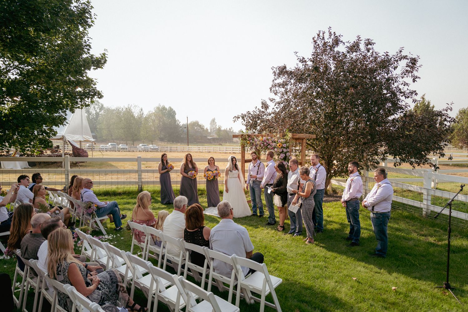 Outdoor ceremony with rows of guests, farm wedding in Oregon.