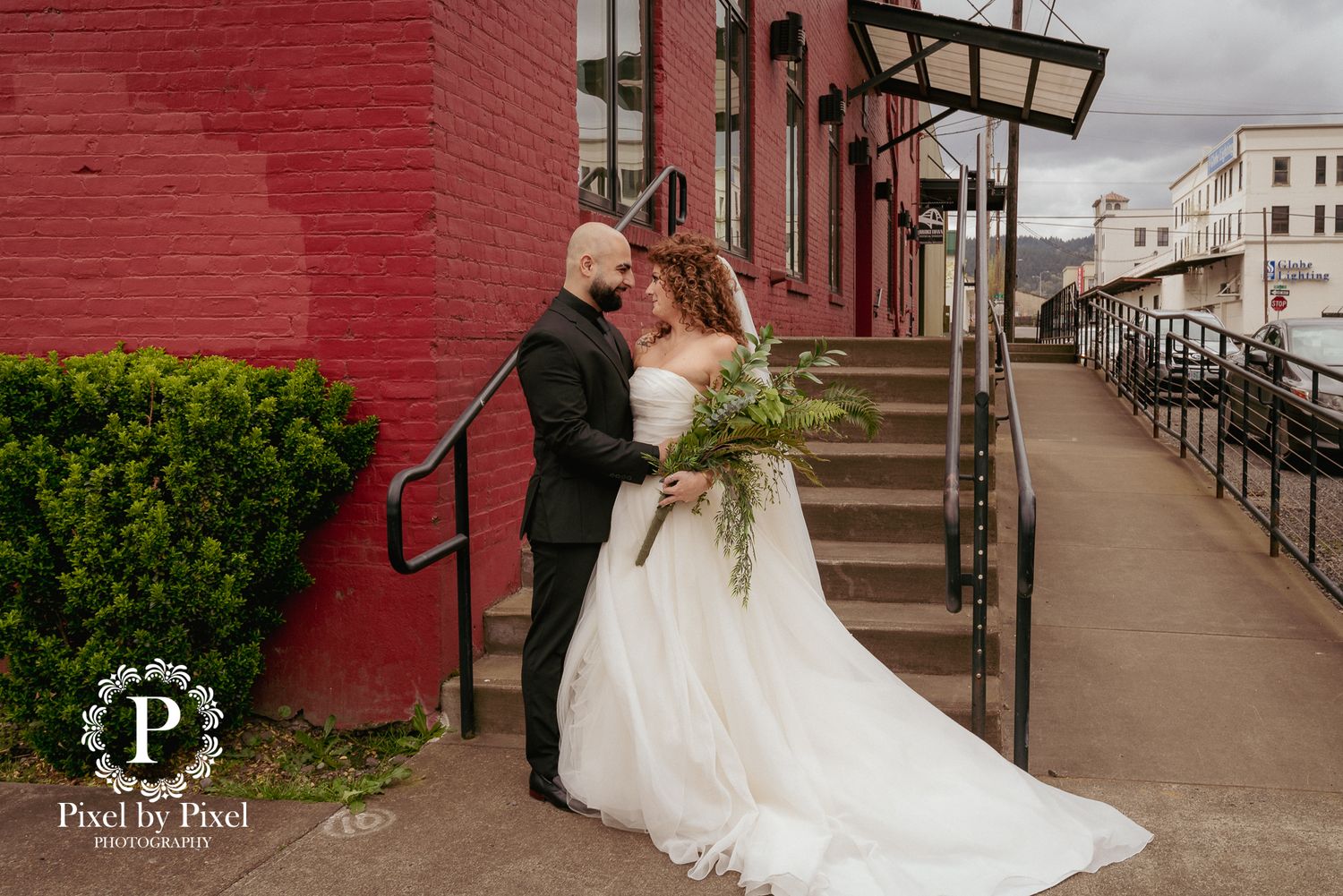 Bride and groom kiss on brick stairs, downtown PDX elopement.