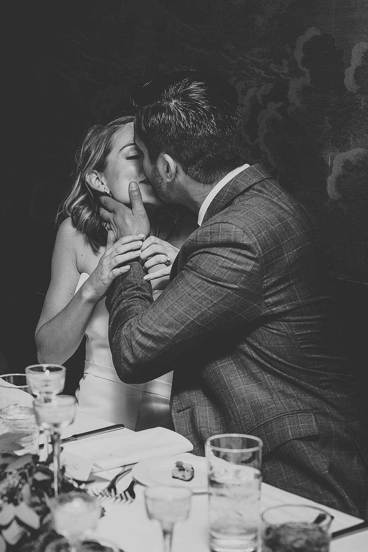 Black and white photo sequence showing tender romantic moment between newlyweds at their wedding reception dinner.