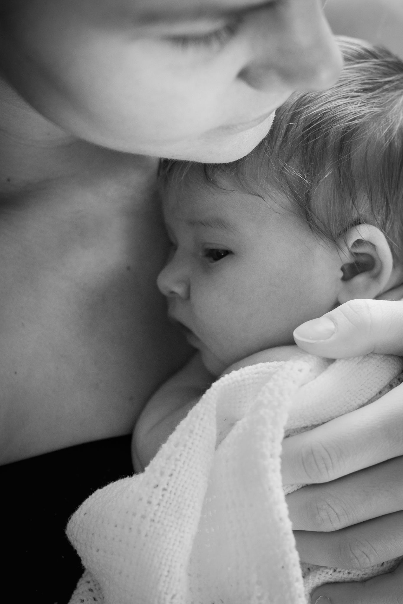 A tender black and white close-up moment between parent and child.
