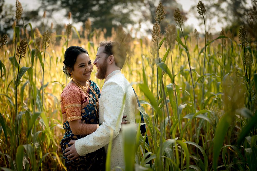 A beautiful Indian-American couple posing in a farm during golden hour.