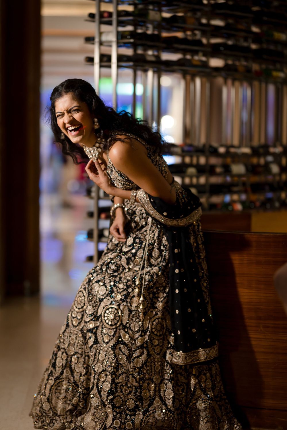 A fun bride in her blue lehenga at her sangeet at Hotel Hyatt Pune