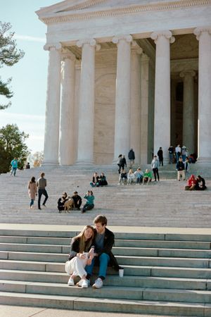 Visitors gather on the steps of the Jefferson Memorial in Washington DC on a sunny day.