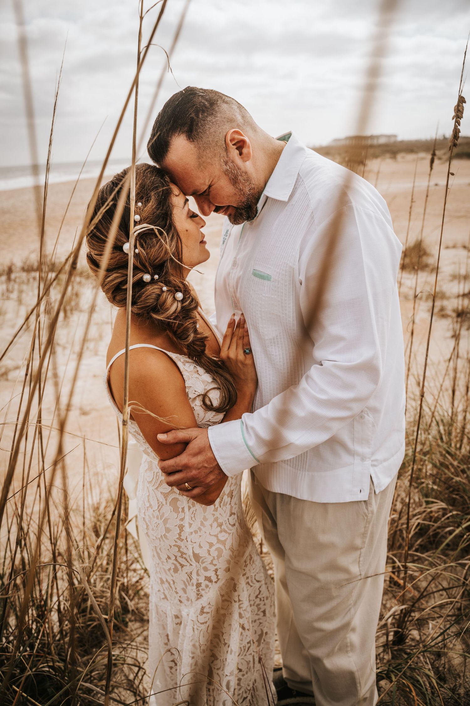 Bride and Groom in tall grass on their wedding day in Anastasia Island Florida
