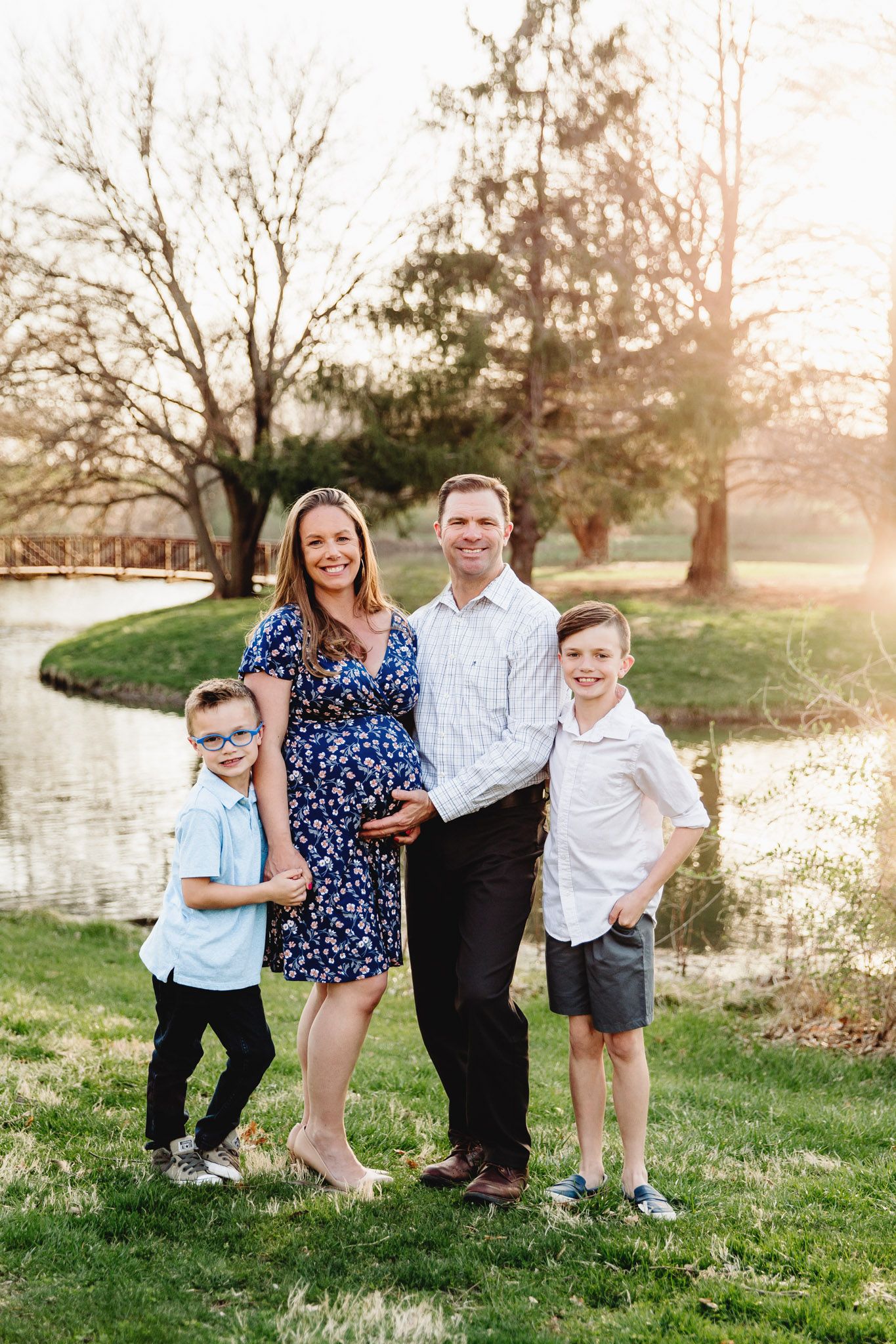 family posed at sunset maternity session
