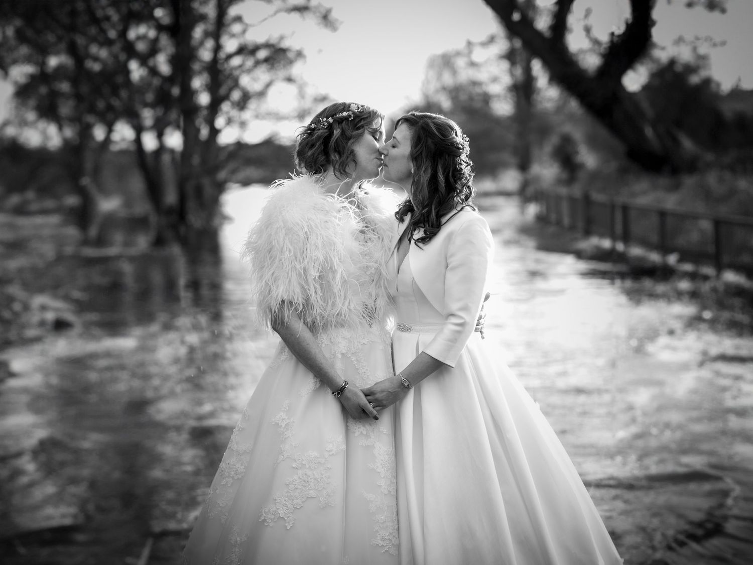 Black and white wedding photography in an outdoor garden setting.