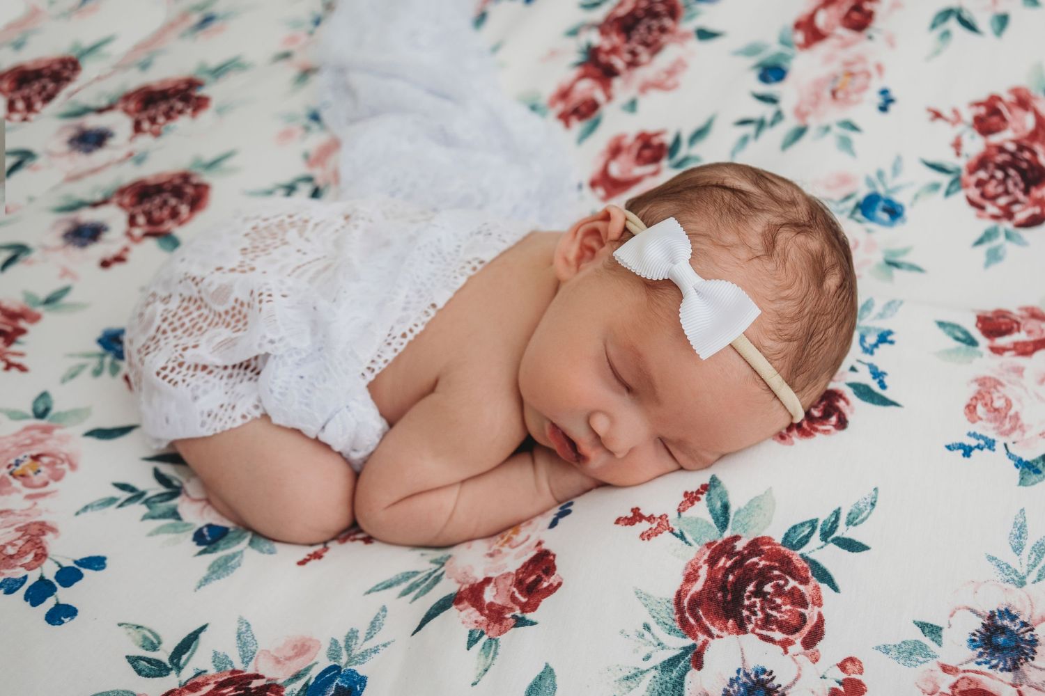 girl floral wrapped newborn posed photographer studio trained skilled professional NY WNY East Aurora buffalo