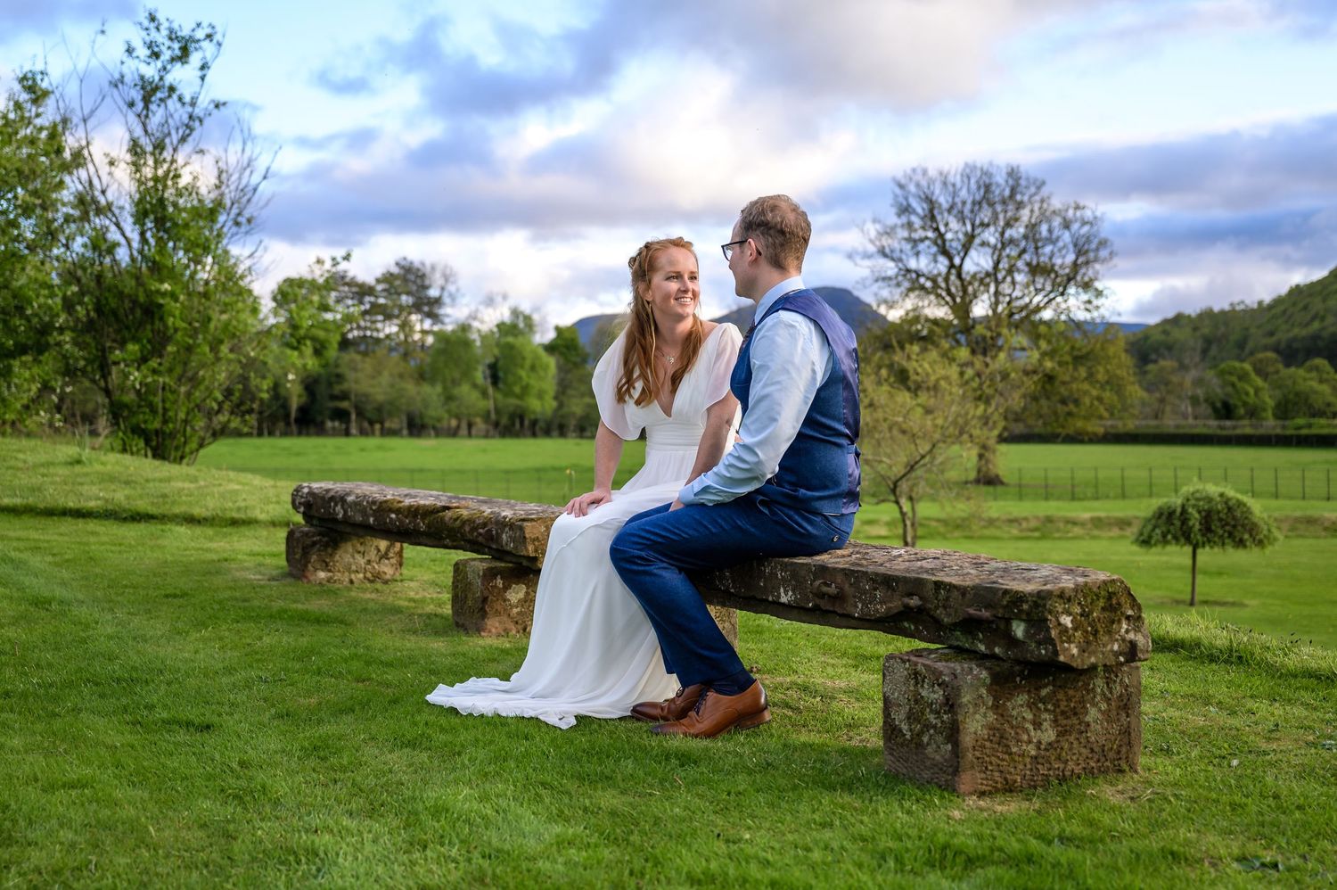 Bride and groom on bench at New House Farm wedding