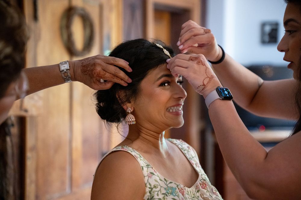 Wedding preparations show final touches being added to a beautiful bridal hairstyle.