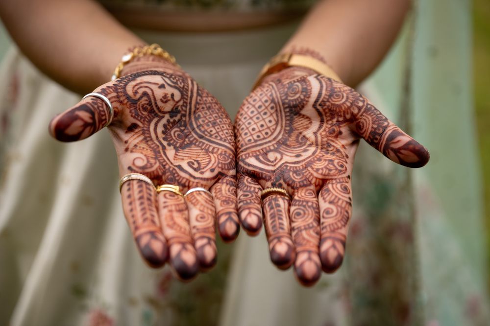 Beautifully detailed henna patterns displayed on both palms in traditional bridal style.