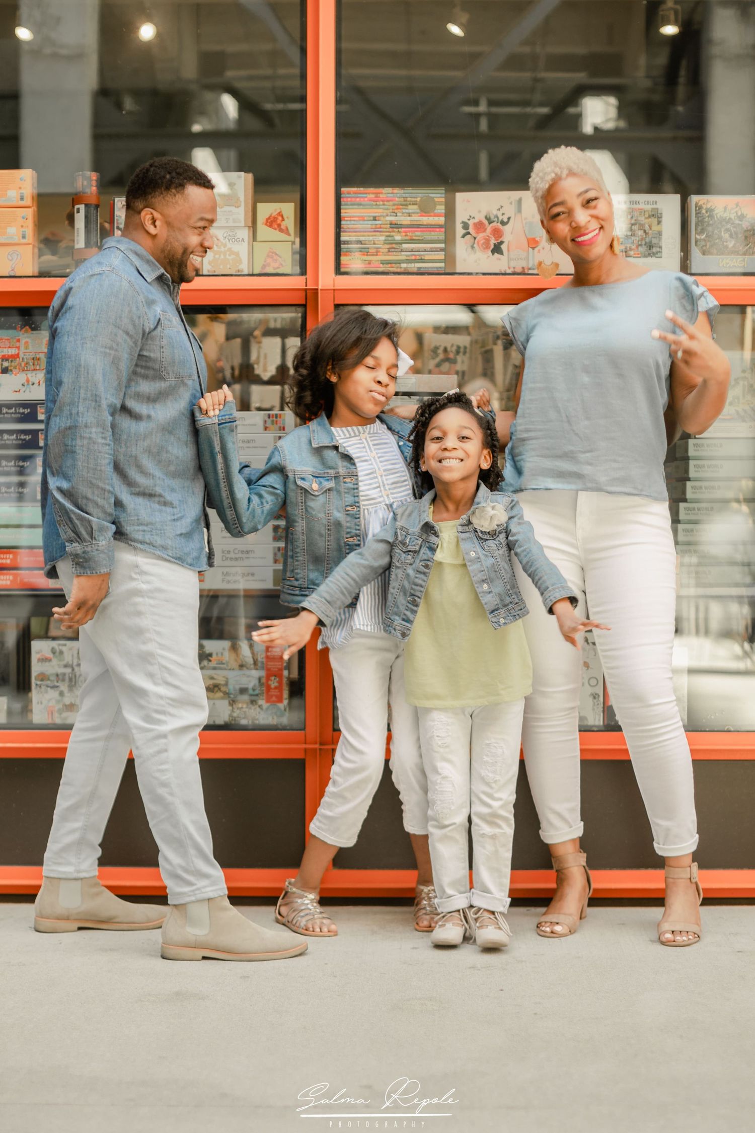 Family's feet and legs shown in coordinated casual outfits during an urban photoshoot.