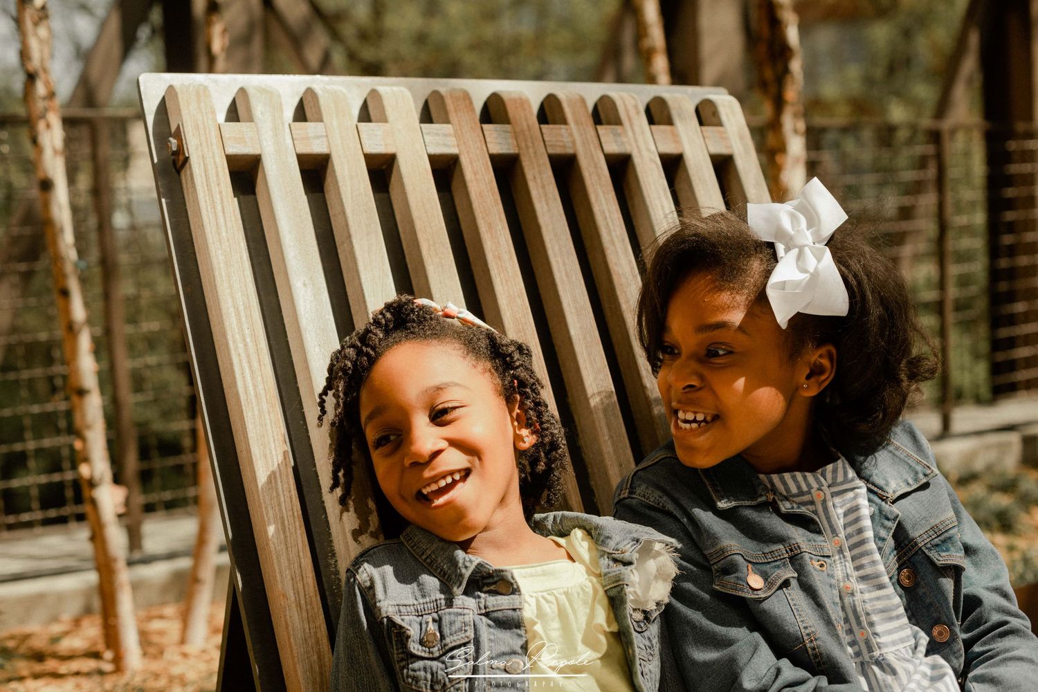 Joyful outdoor portrait session with people laughing against a natural background.