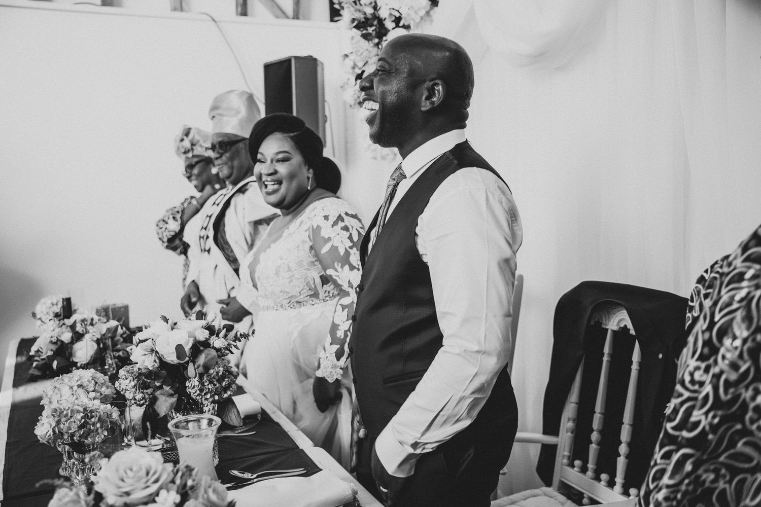 Black and white photo of wedding celebration with decorative elements.