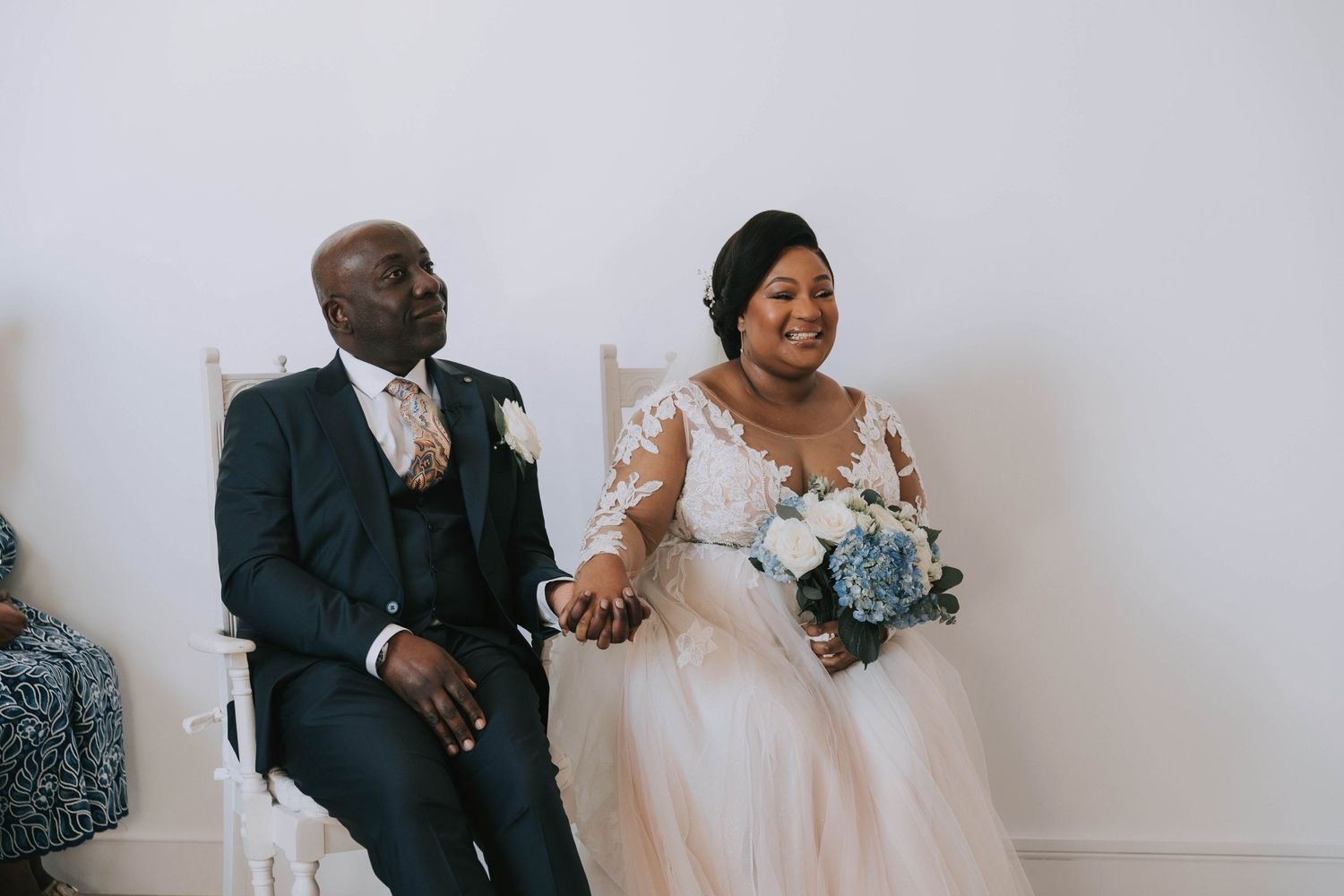 Wedding ceremony moment captured in an elegant white venue setting.