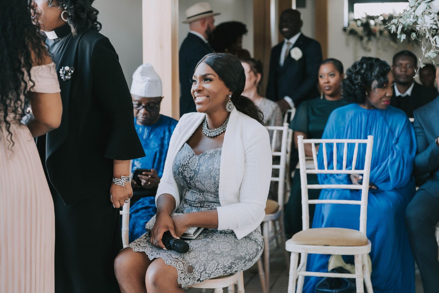 Wedding guests gather for a celebration with blue and white decor elements.