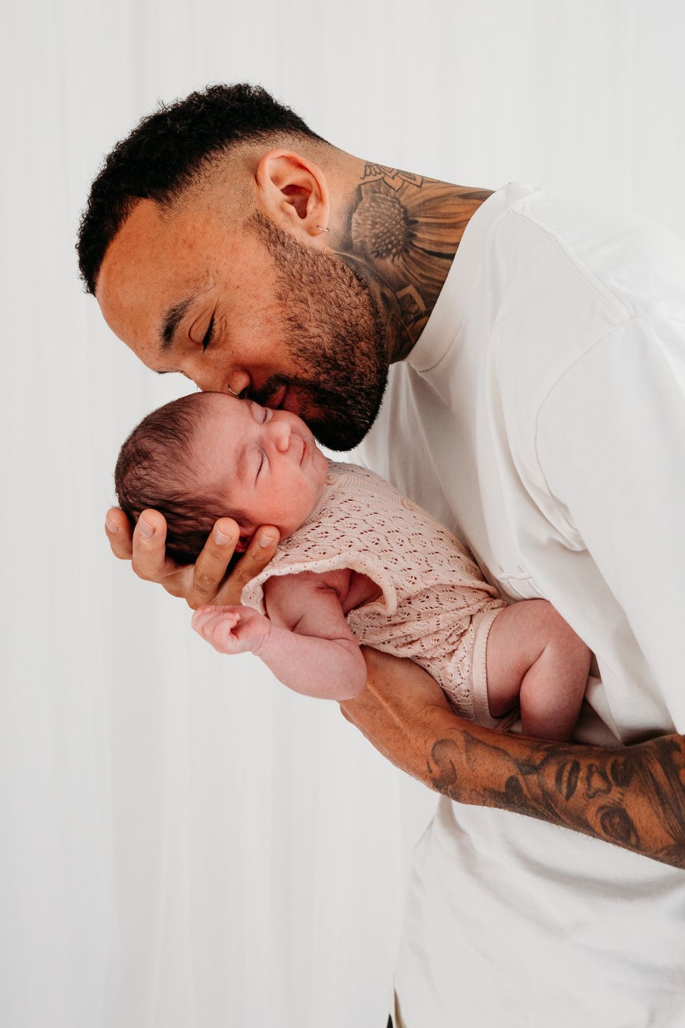 Nottingham family photographer capturing relaxed studio portraits with parents and children in timeless, natural style.