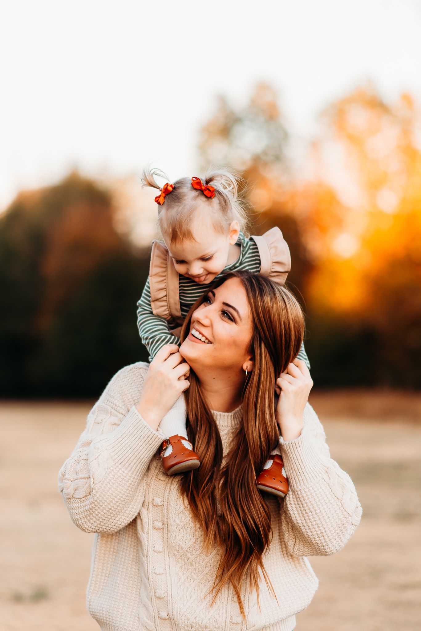 Joyful moment captured between parent and child during golden hour sunset.