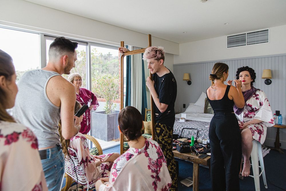 A busy getting-ready scene in a bright room with floral robes.