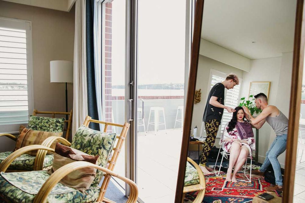 A candid moment captured through a reflection in a bright modern room.