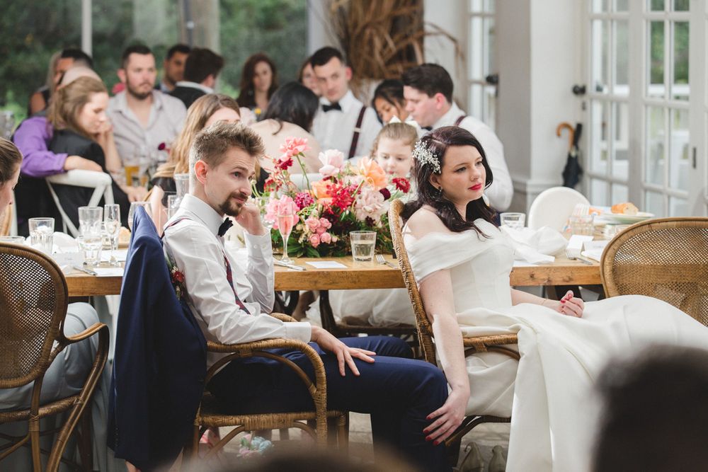 Wedding reception venue with white chairs and tables arranged for dining and celebration.