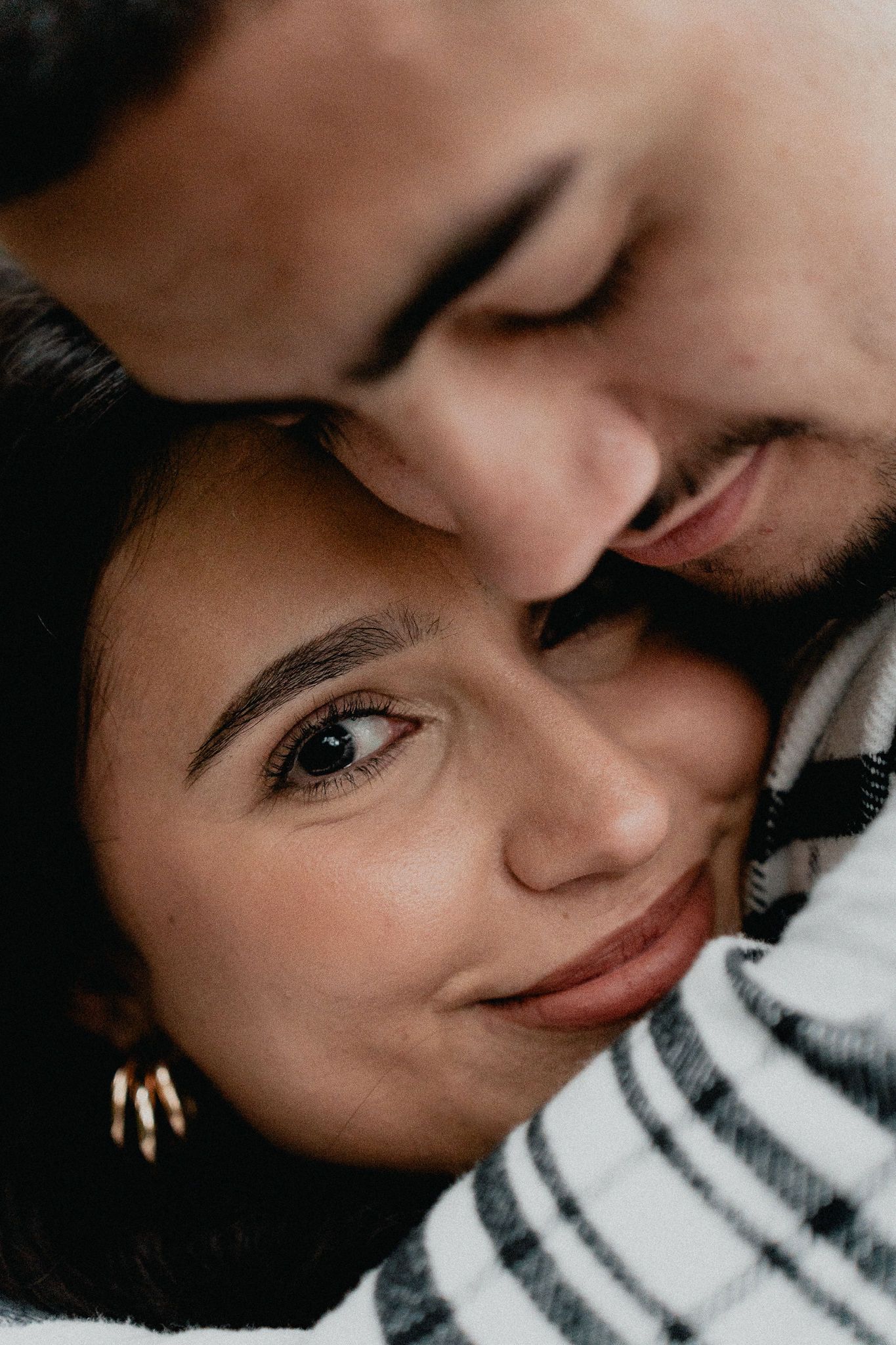 Intimate close-up portrait shot with soft lighting and gentle expressions.