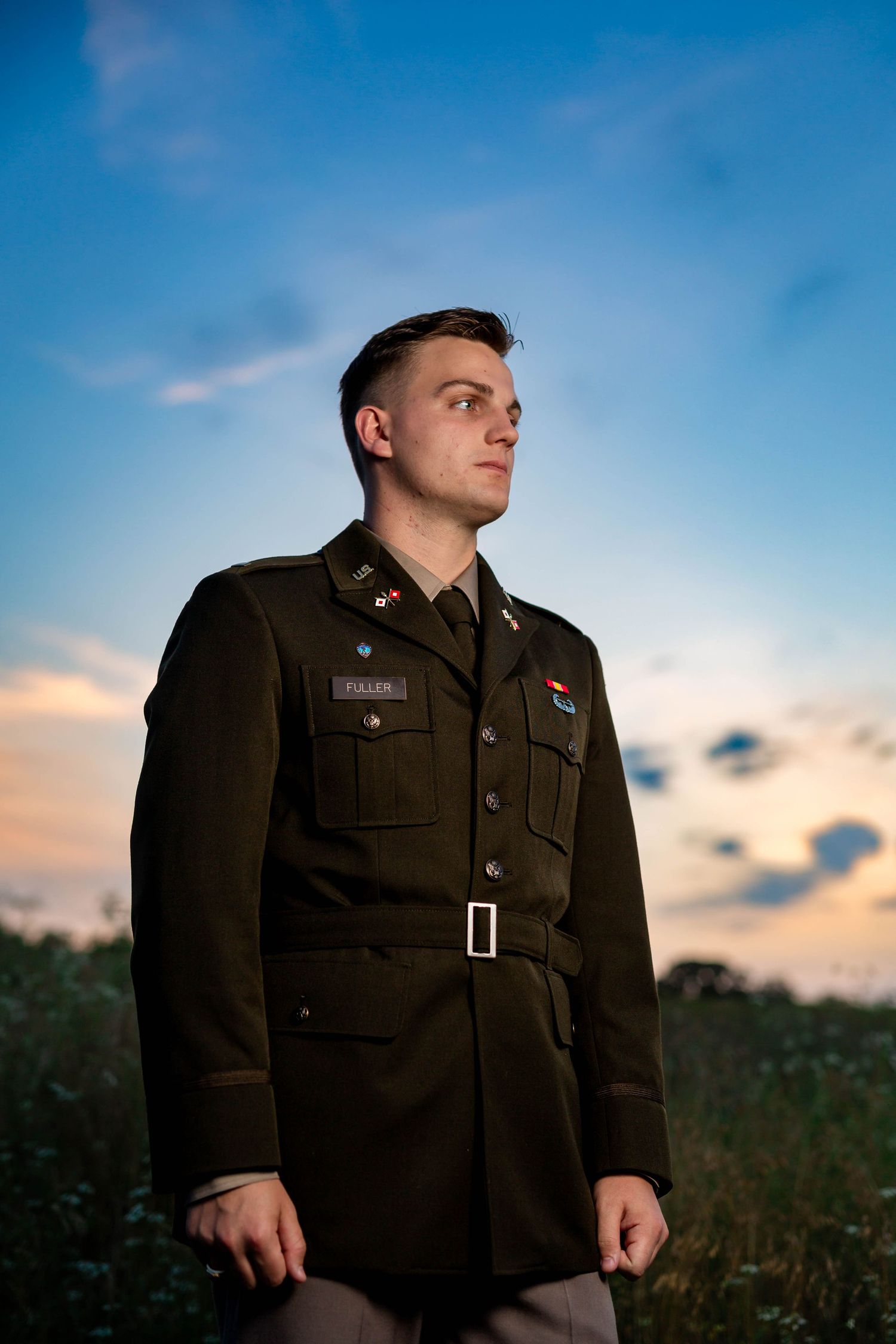 Groom in military dress uniform at sunset during his Osage House wedding in Cave Springs, Arkansas