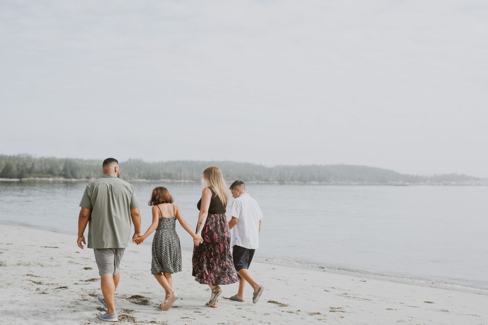 Family walking on beach. Photo by Samantha Bateman.