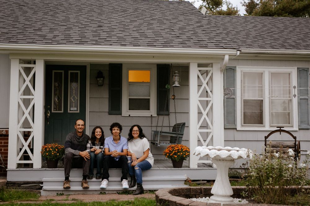 Family sitting on front porch. Photo by Samantha Bateman.