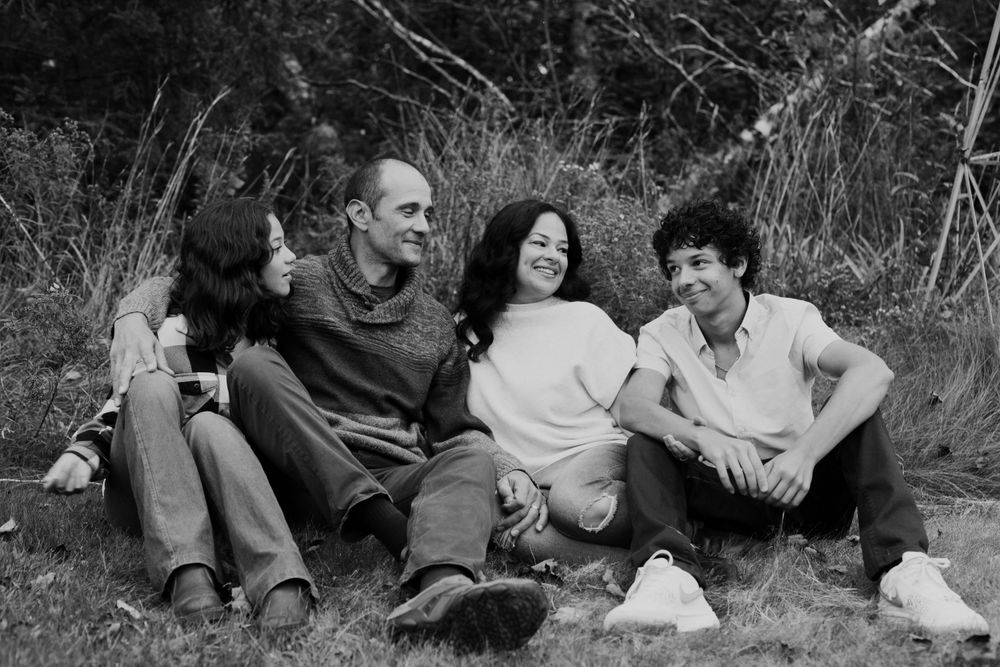 Family sitting in grass. Photo by Samantha Bateman.