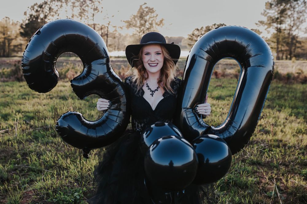 Large blue balloon numbers displayed in outdoor setting during golden hour.