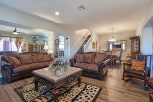 Spacious open concept living room with traditional leather furniture and southwestern decor.