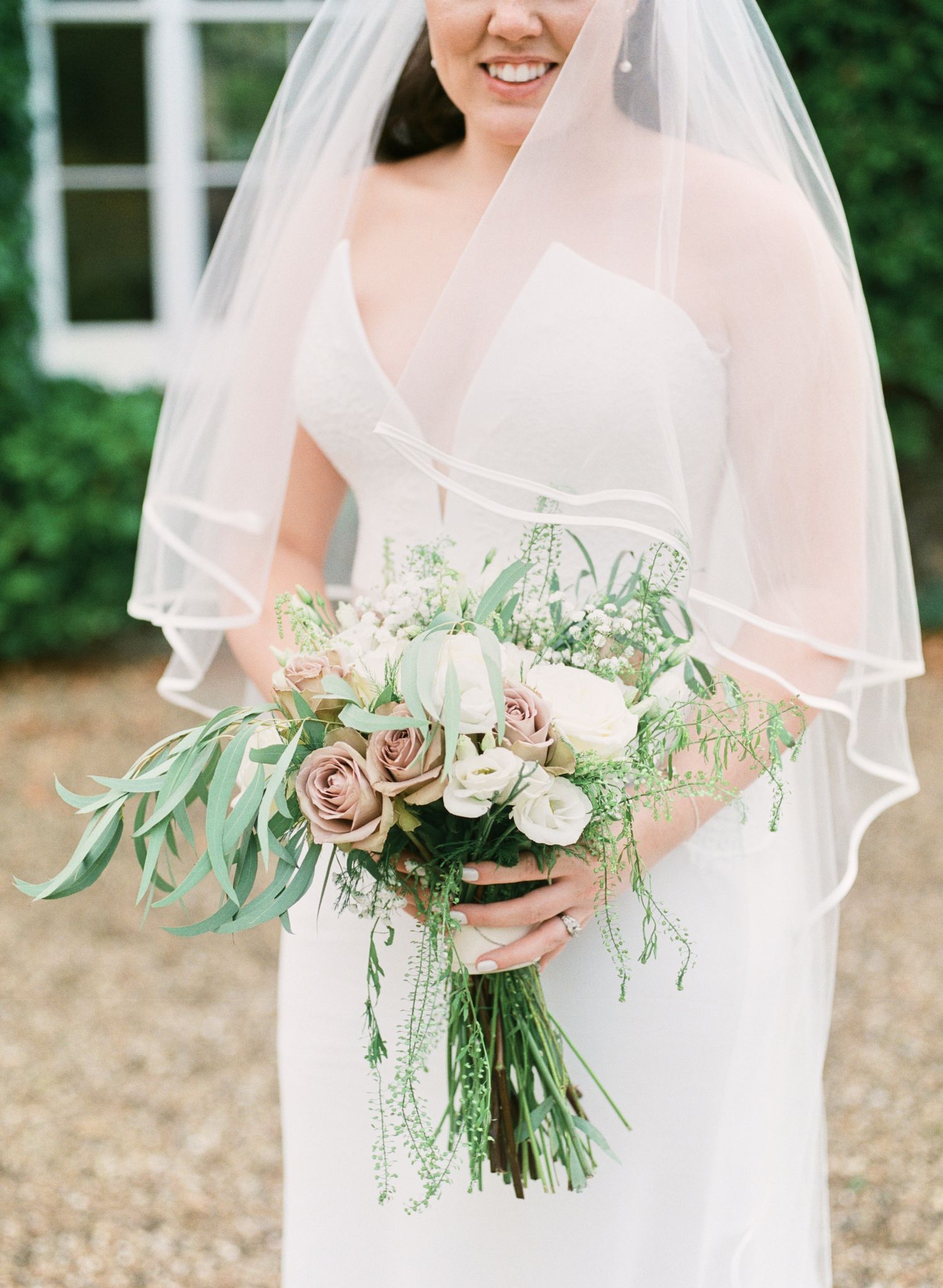 beautiful portrait of bride holding bouquet at luxury venue Bressingham Hall, Norfork. by Faye Amare photography on film
