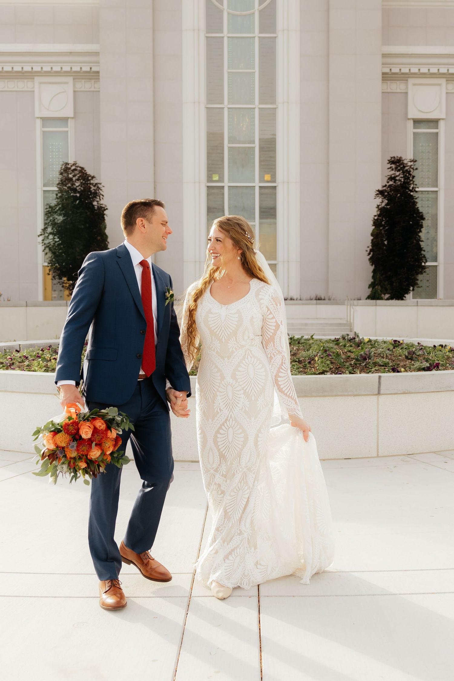 Bride and Groom walking together hand in hand at the Mount Timpanogos Utah LDS Temple
