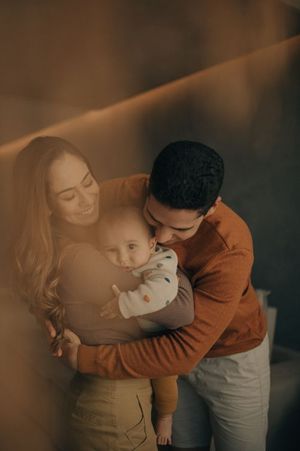 Intimate family moment captured in warm sepia tones.