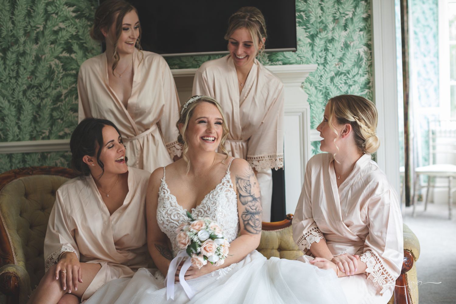 Bride with her bridesmaids during bridal preparation in Trunkwell House, wedding photographer.