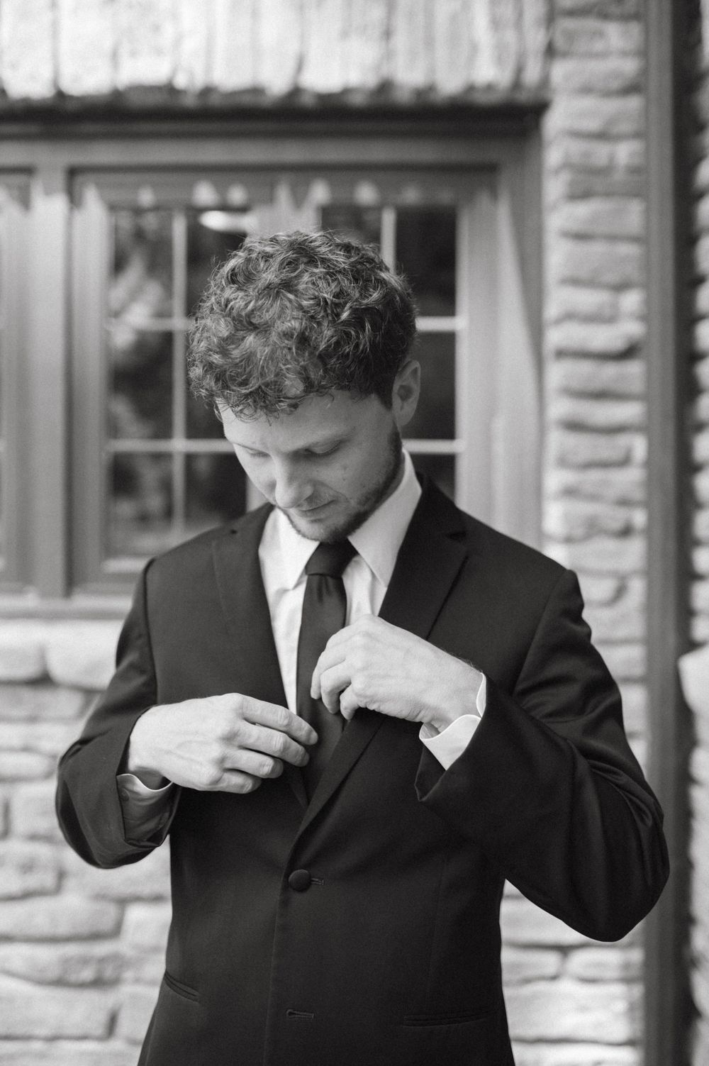 Black and white portrait of formal attire preparation.