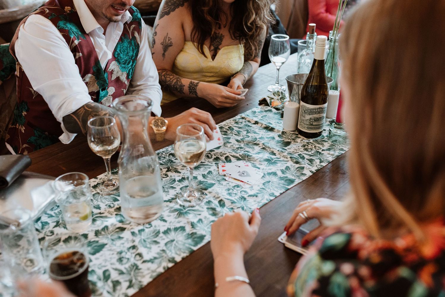 candid wedding photographer in powys of friends playing cards at wedding