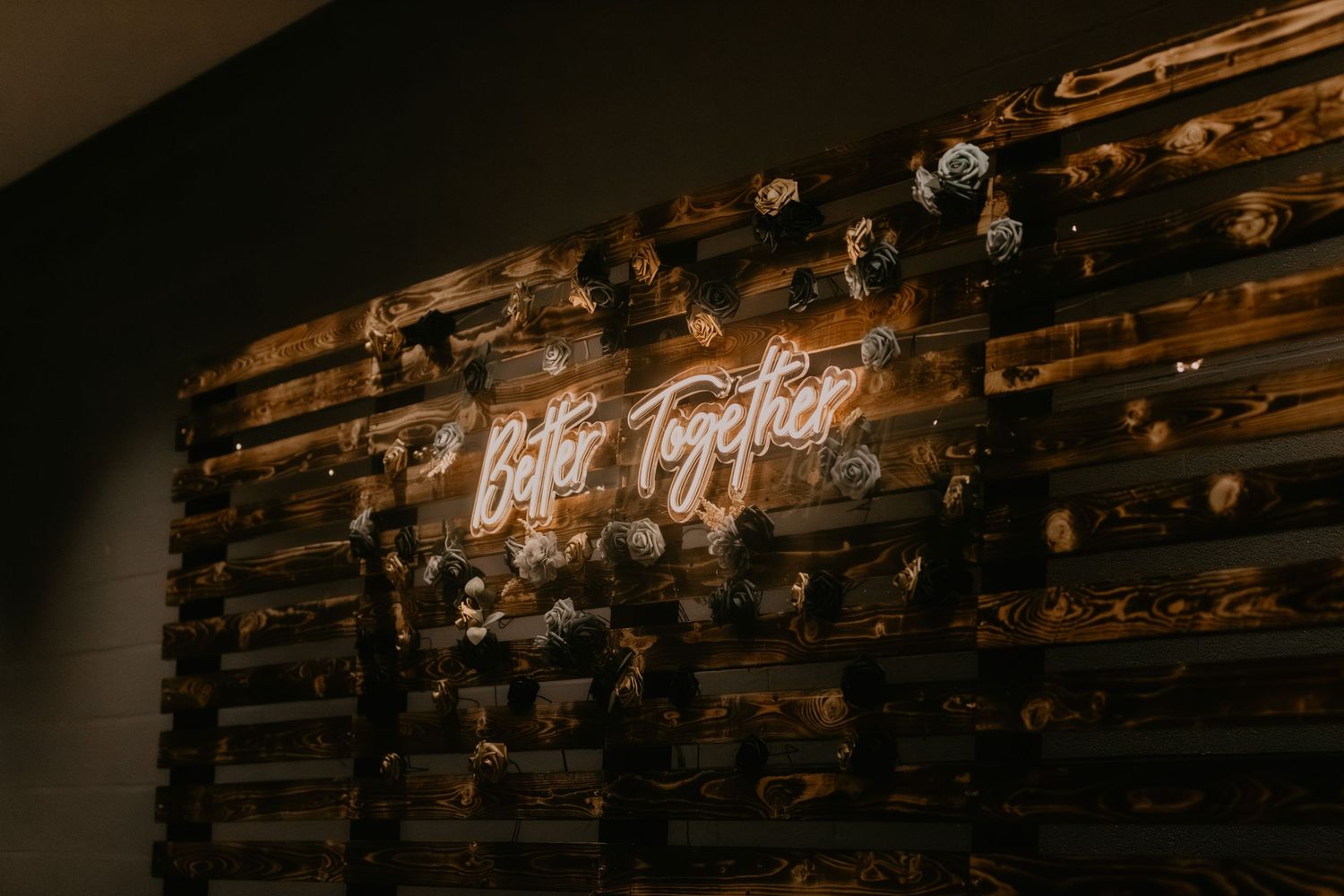 Neon sign reading 'wife life' mounted on rustic wooden wall decorated with small lights.