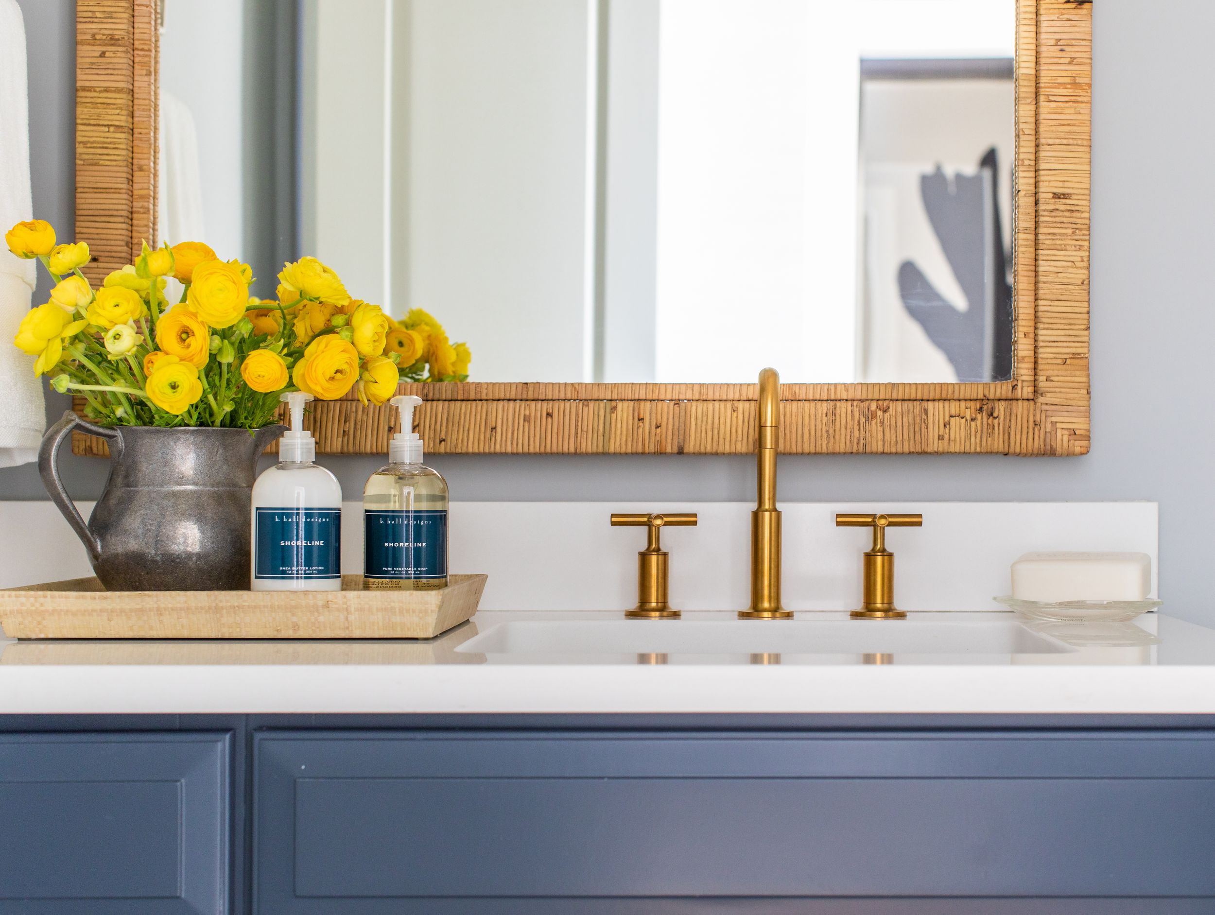 Blue and white kitchen with gold hardware and navy cabinets