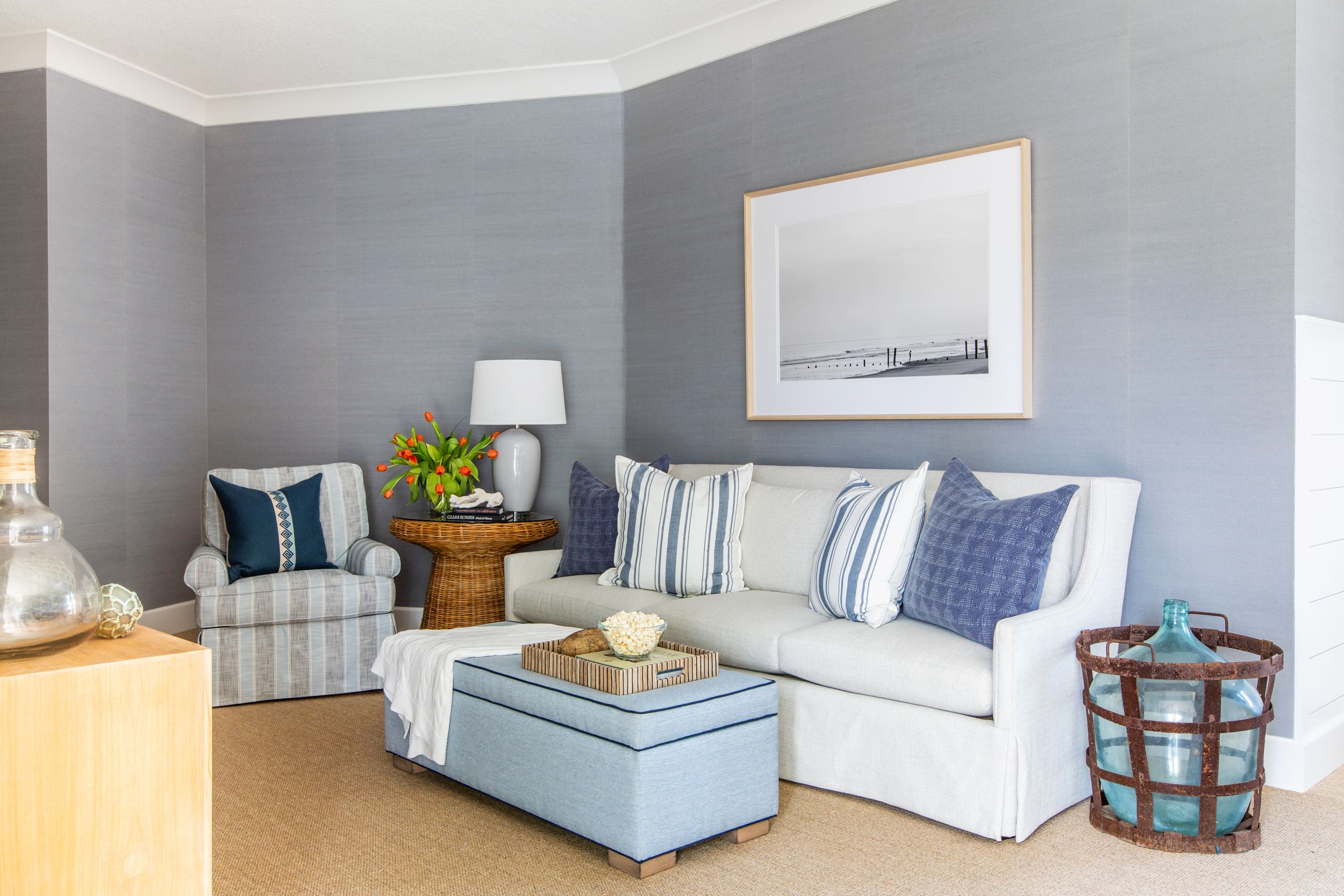 Coastal family room with jute rug, white sofa and Phillip Jeffries wall covering.