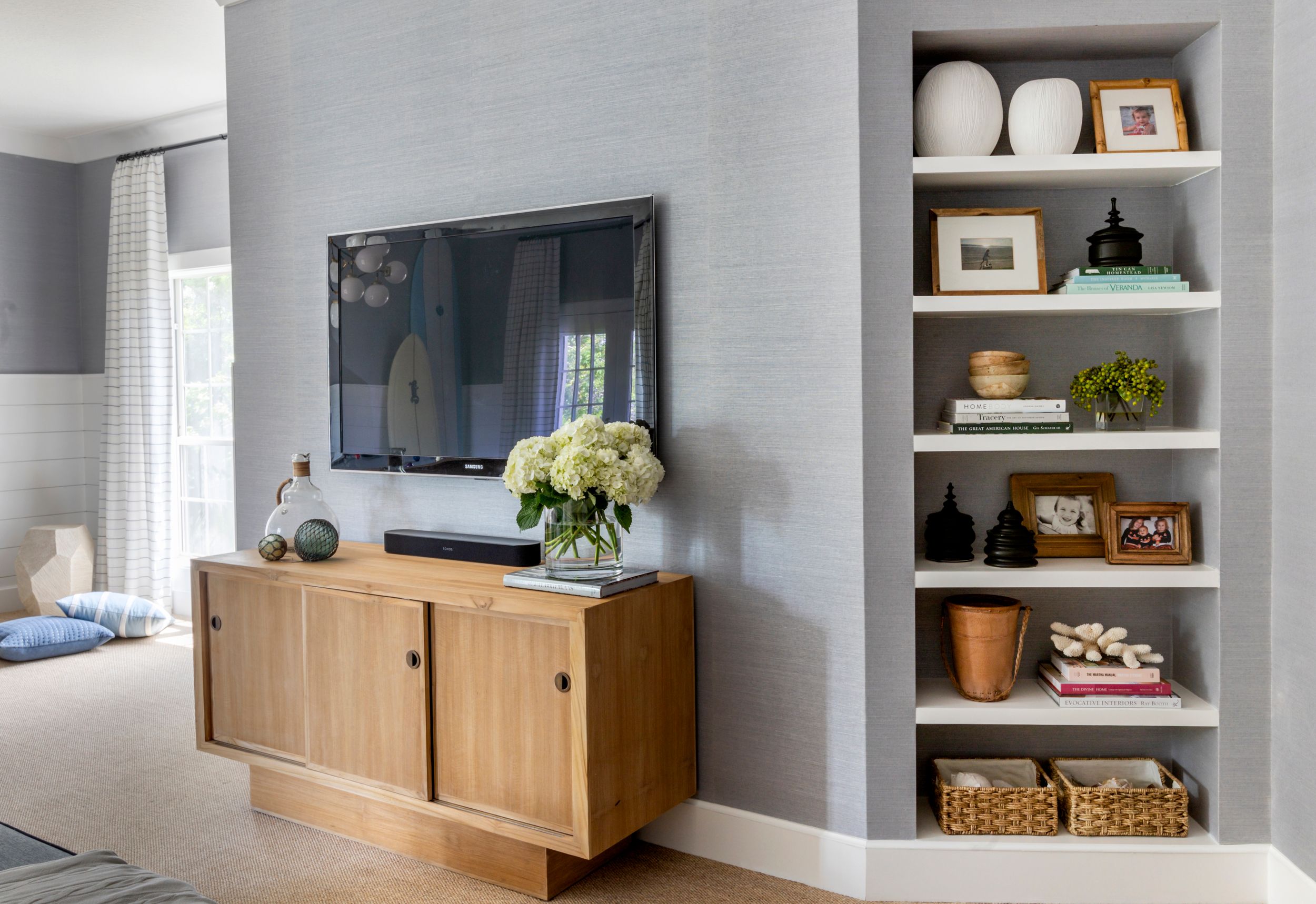 Custom built shelving and Lee Industries furniture in coastal family room.