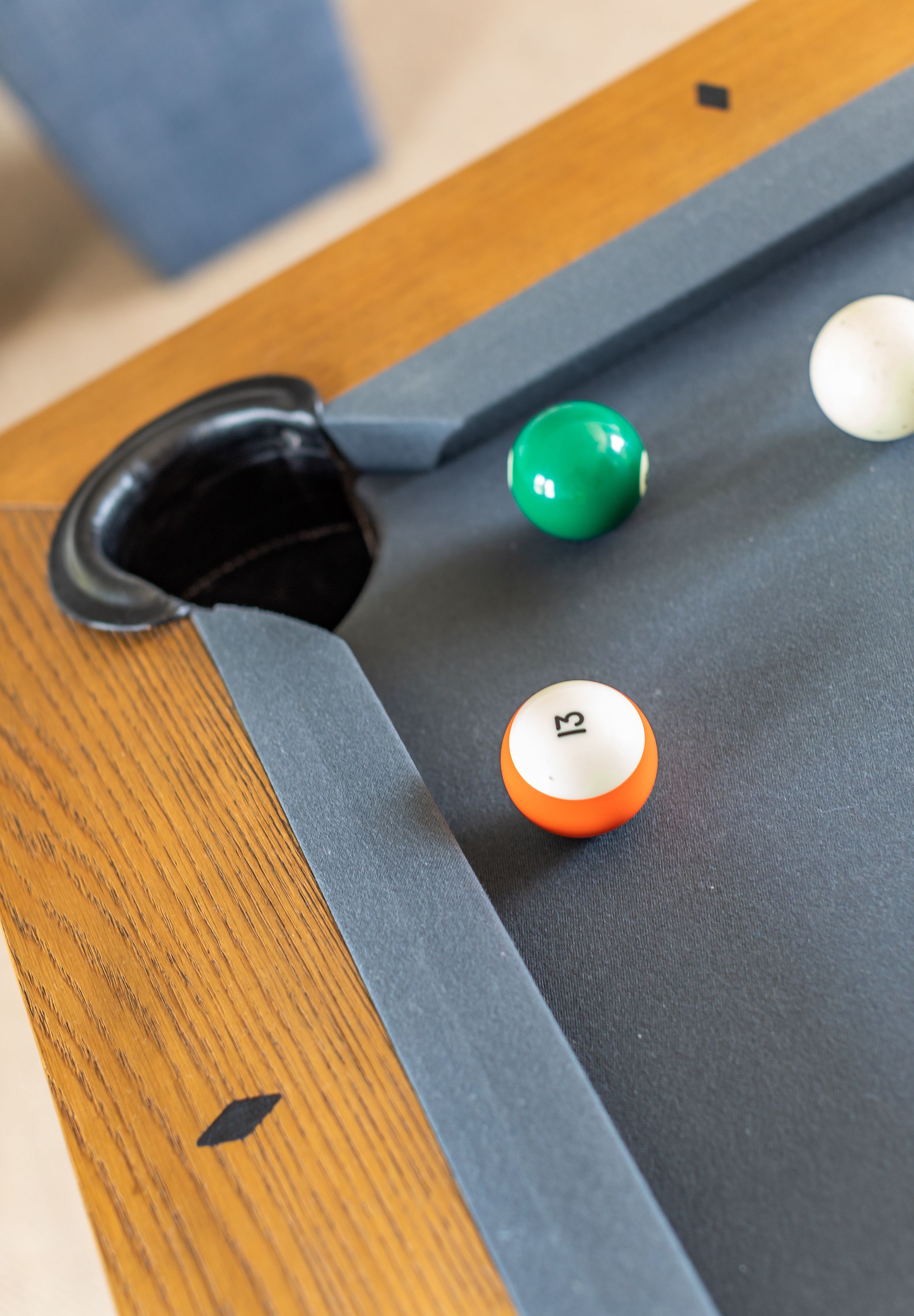 Close up of wooden pool table in family game room.