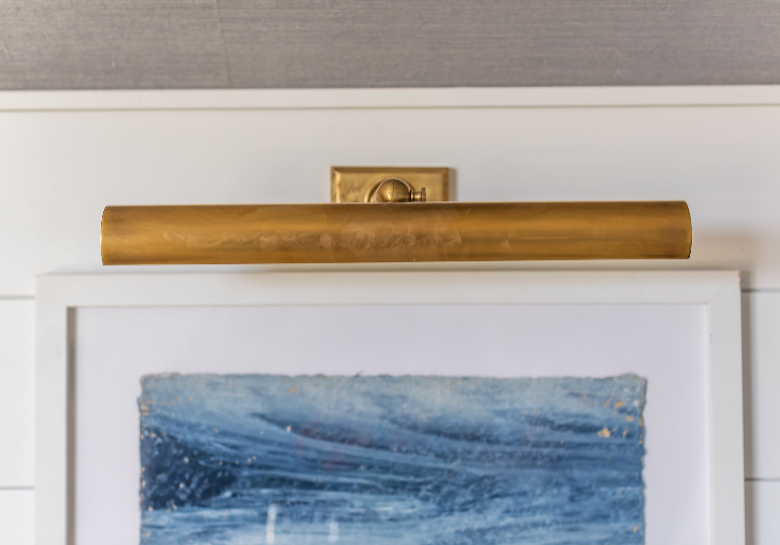 Coastal blue painting with antique, brass frame.