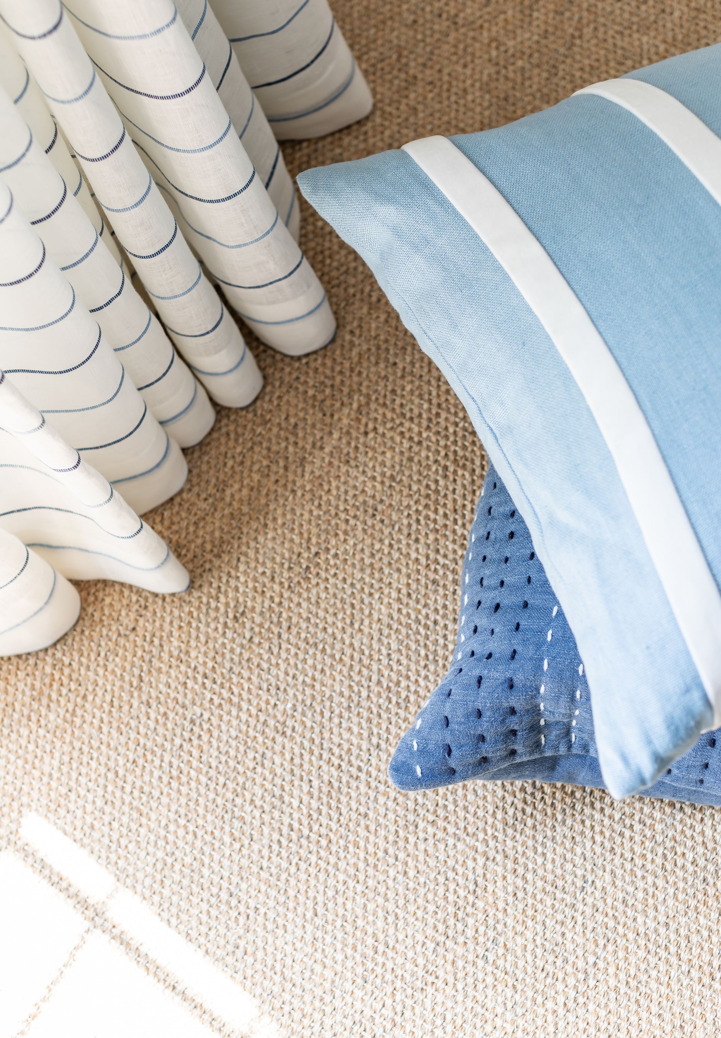 Blue and white coastal modern decor with tan jute rug