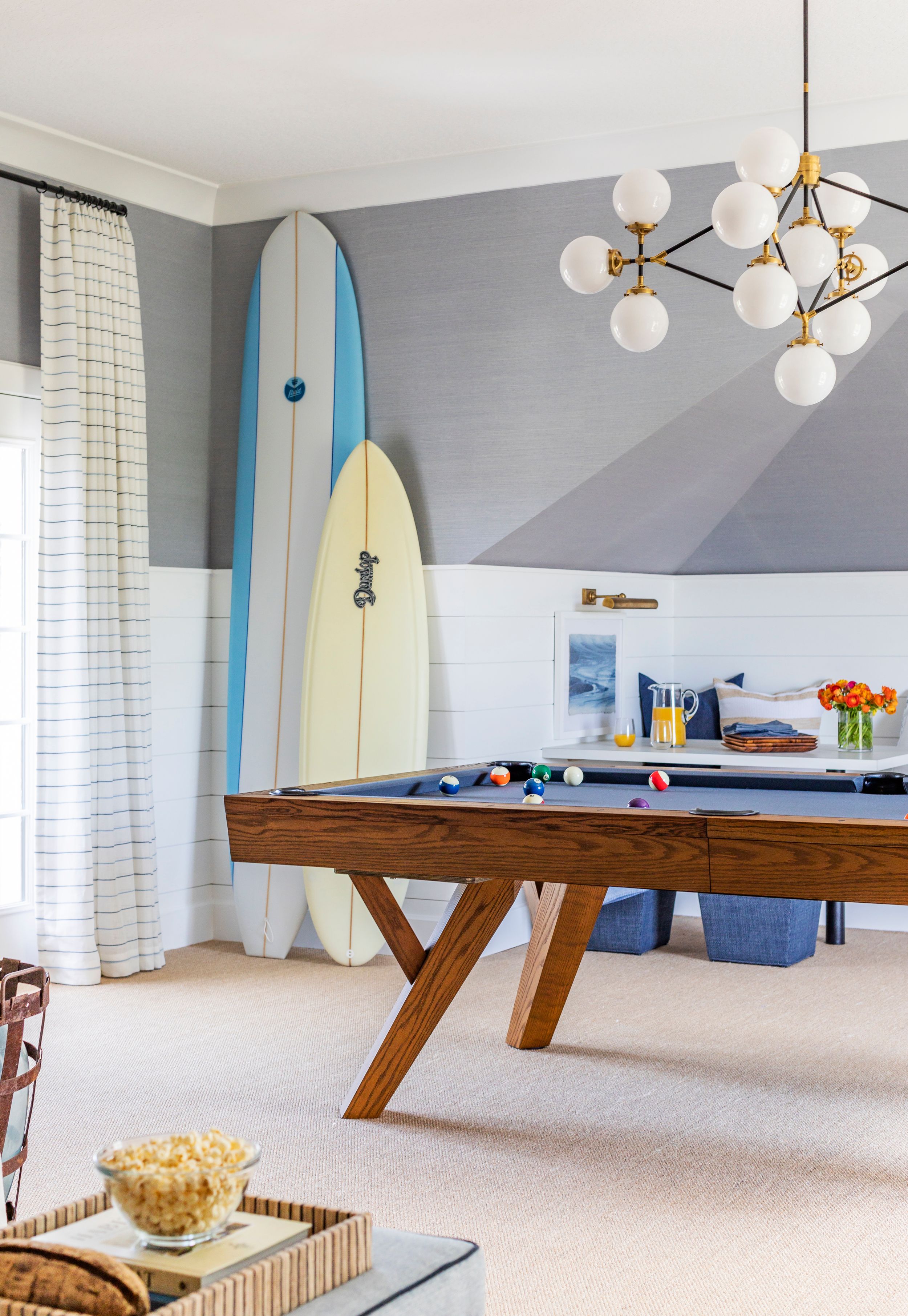 Coastal family game room with MCM pool table and Visual Comfort chandelier.