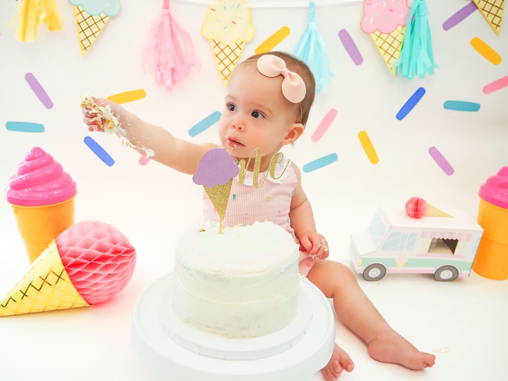 cake smash with balloons and white cake. little girl eating cake. sweet one themed. Santa Rosa, California. Sonoma County photographer